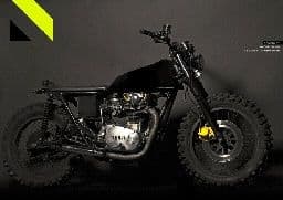 a black motorcycle parked in a dark room