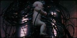 a naked man standing in front of a bunch of wires