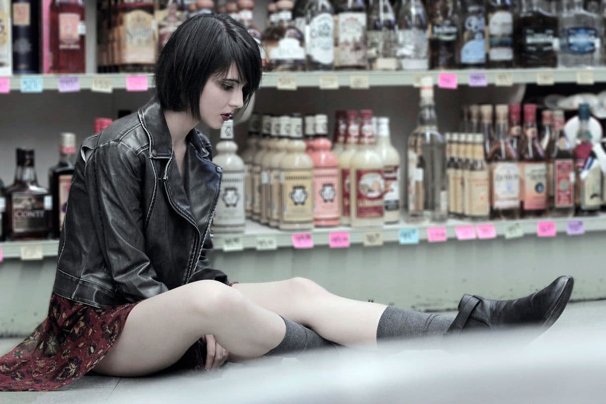 a woman sitting on the ground in a store