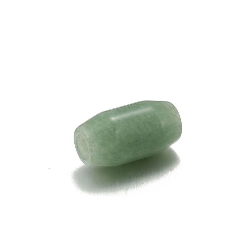 a green pill sitting on top of a white surface