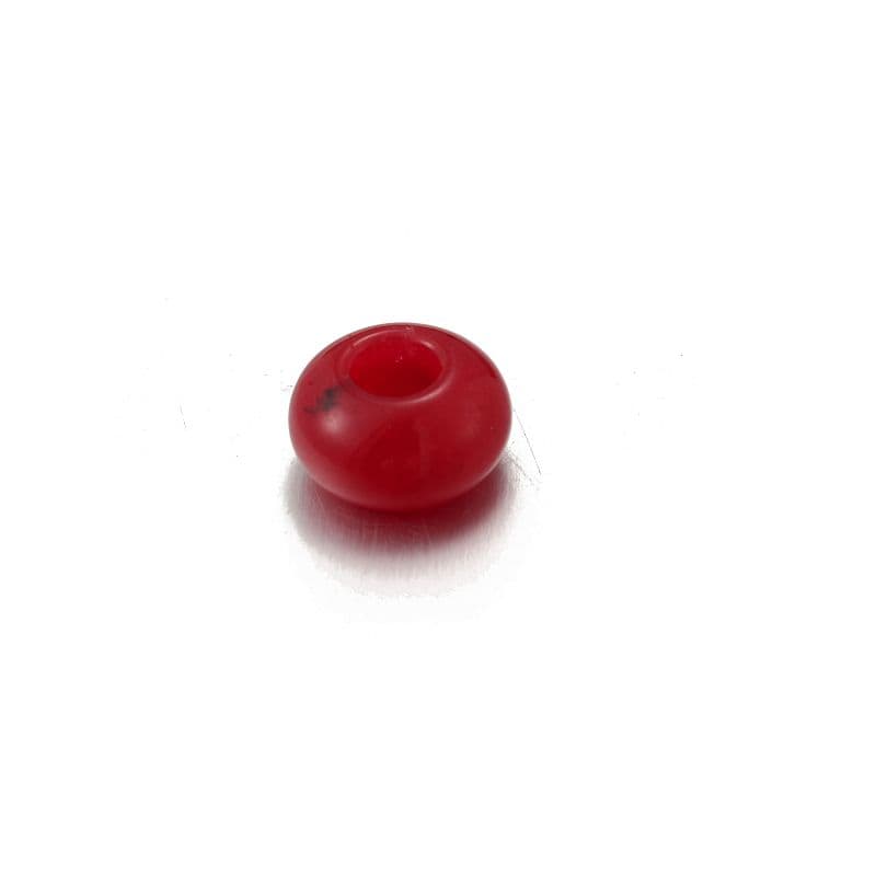 a red object sitting on top of a white surface