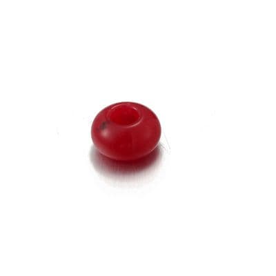 a red object sitting on top of a white surface