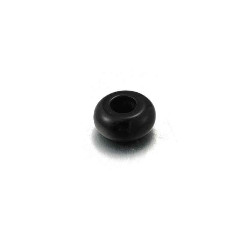 a black plastic object on a white surface