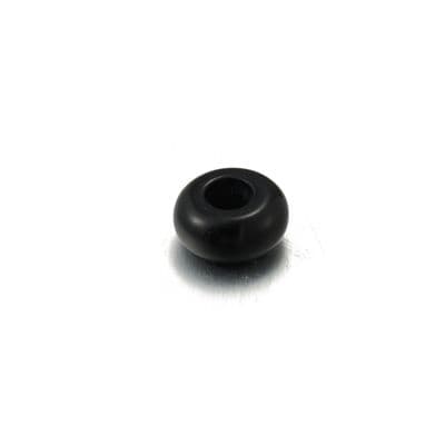 a black plastic object on a white surface