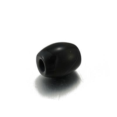 a black object sitting on top of a white surface