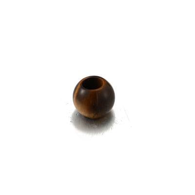 a brown vase sitting on top of a white table