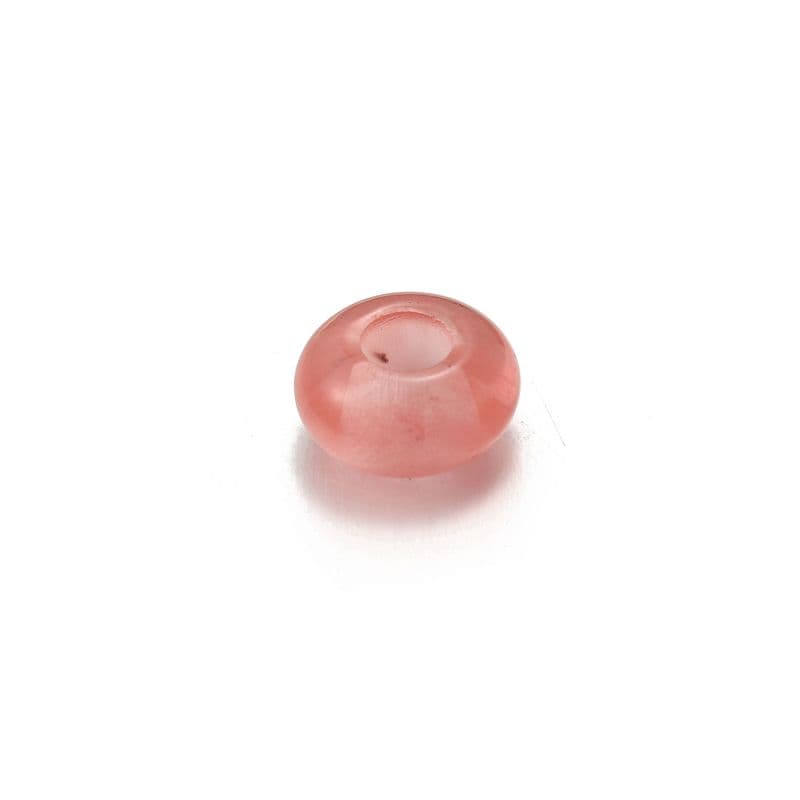 a pink bead on a white background