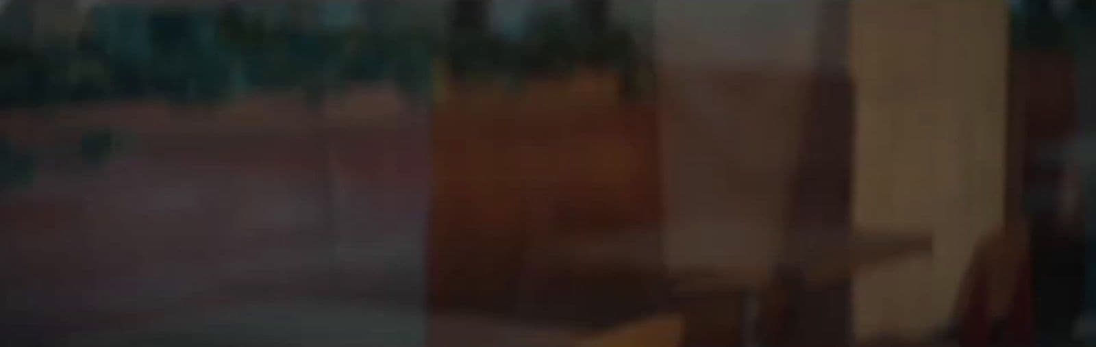 a blurry photo of a building with trees in the background