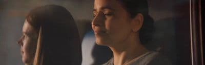 a woman looking at herself in a mirror