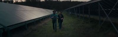 a couple of people that are standing in the grass