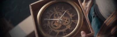 a person holding a clock in their hand