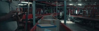 a man standing in a warehouse next to boxes
