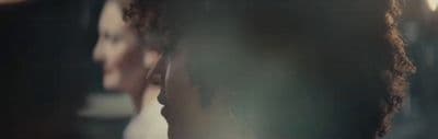 a close up of a woman's head in a mirror