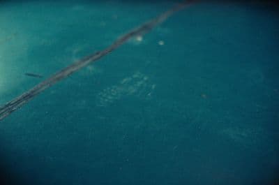 a close up of a blue surface with a blurry background
