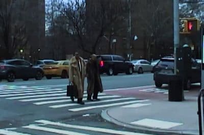 a couple of people that are walking across a street