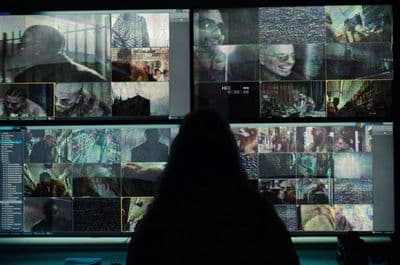 a person sitting in front of a large display of images