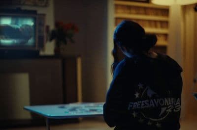 a woman standing in a living room in front of a tv