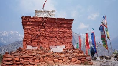 a stone structure with flags on top of it