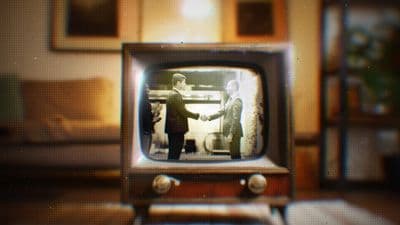 an old television with two people shaking hands