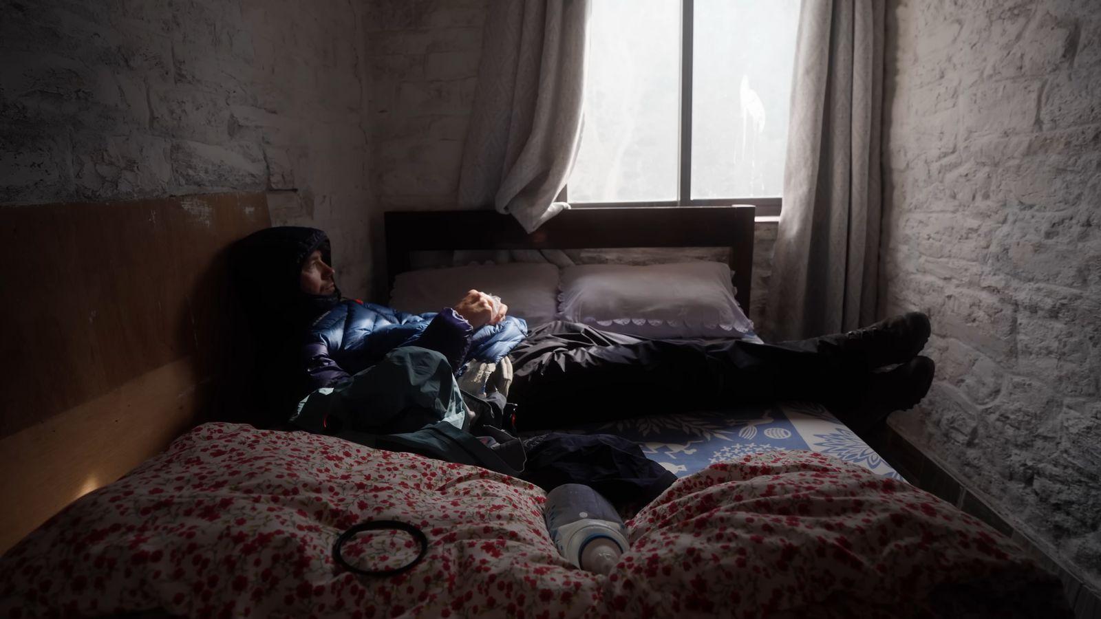 a person laying on a bed in a room
