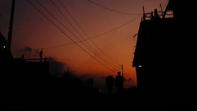 a couple of people that are standing in the dark