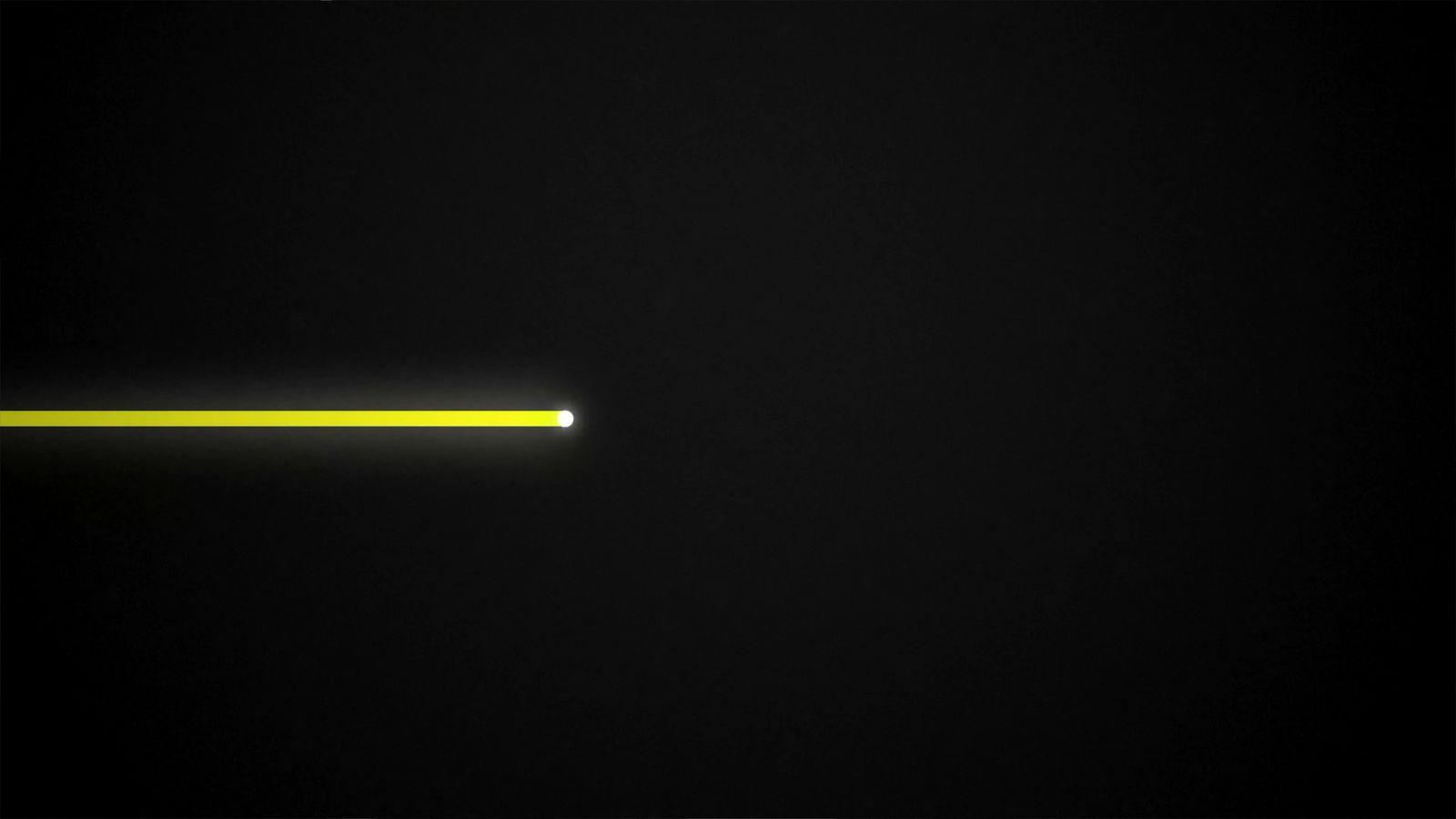 a black background with a yellow light in the middle
