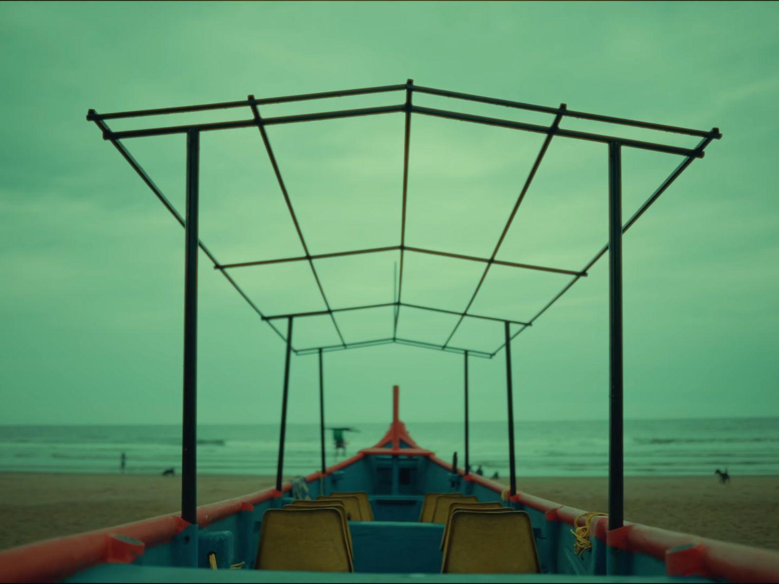 a boat sitting on top of a sandy beach