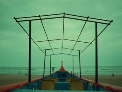 a boat sitting on top of a sandy beach