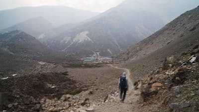 a person hiking up a mountain trail in the mountains
