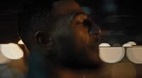 a close up of a man's face with blurry lights in the background