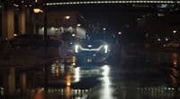 a car driving down a street at night