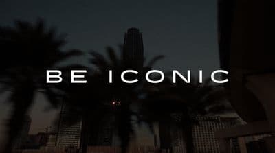 a city skyline with palm trees and the words be iconic