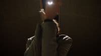 a person holding a cell phone up to their face
