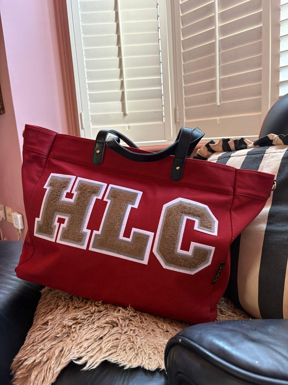 a red bag sitting on top of a black chair