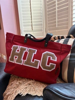 a red bag sitting on top of a black chair
