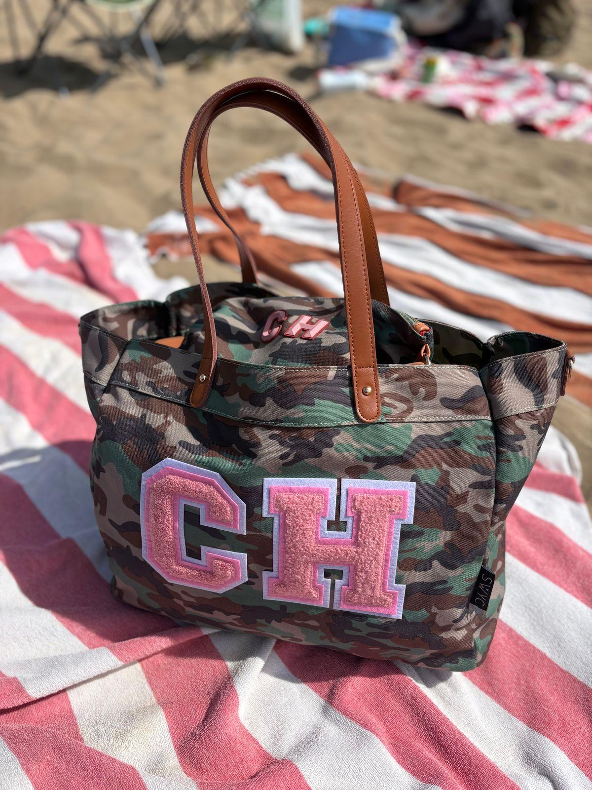 a camo bag with the letter gh on it