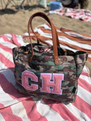 a camo bag with the letter gh on it