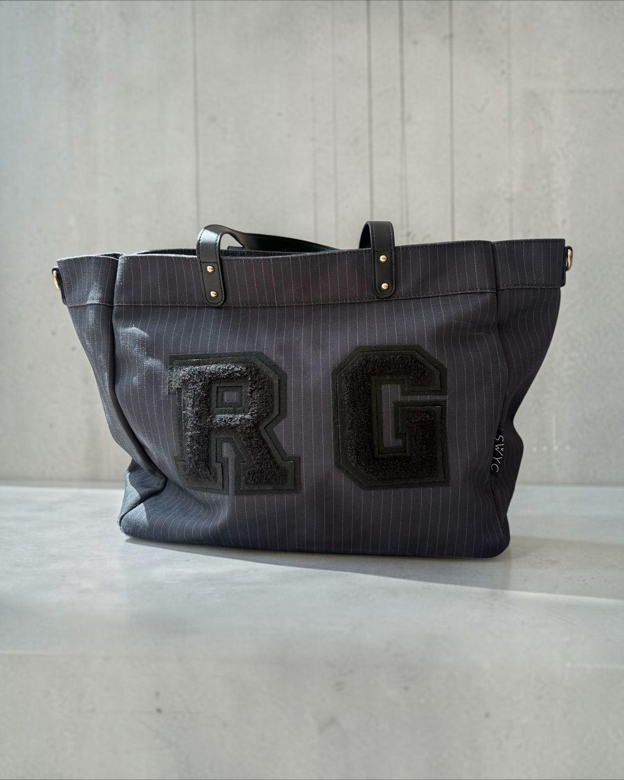a gray bag with the letter r on it