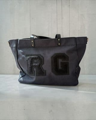 a gray bag with the letter r on it