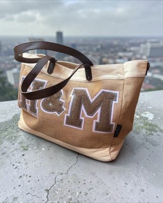 a brown and white bag sitting on top of a cement wall
