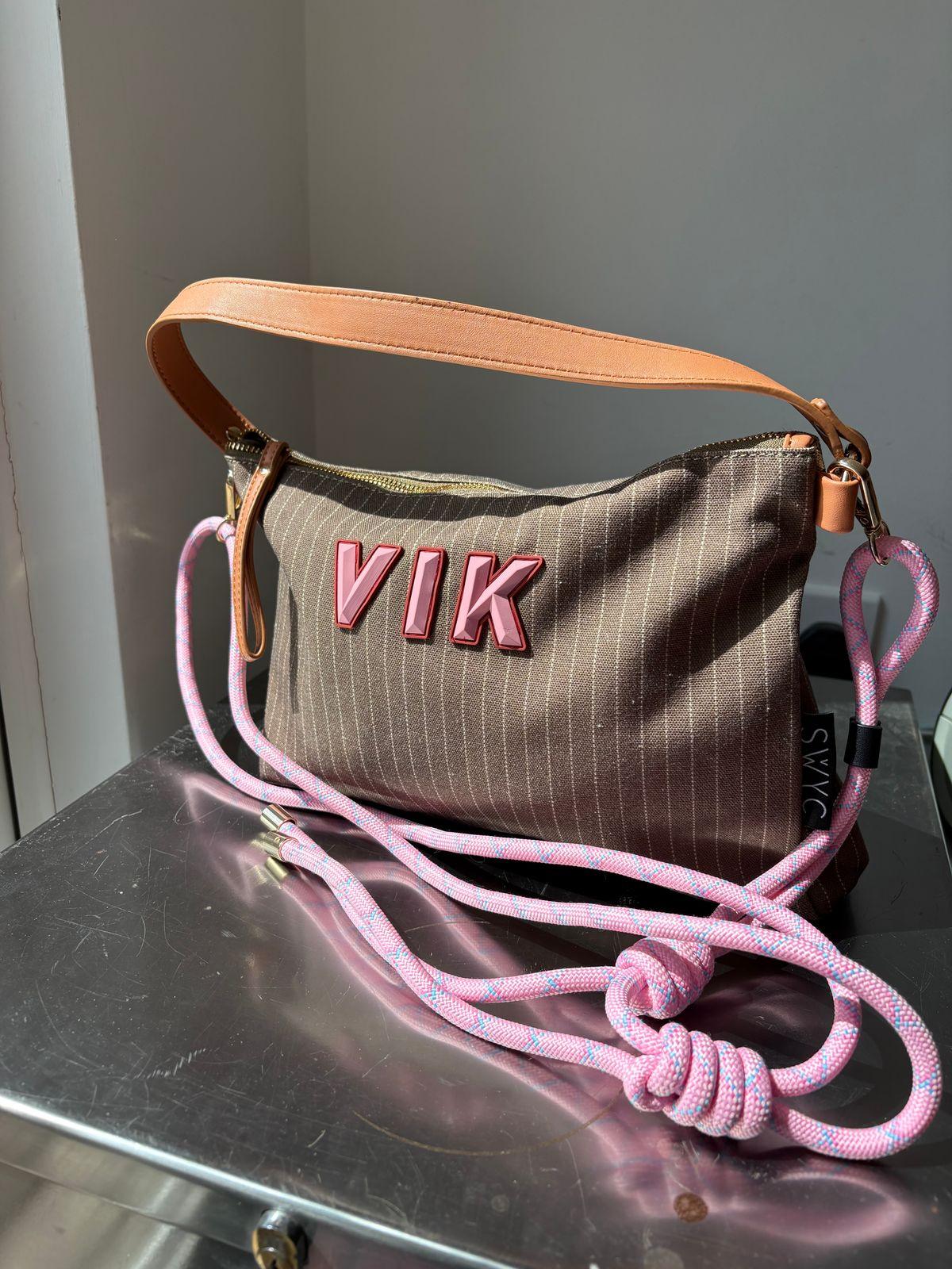 a brown and pink purse sitting on top of a table