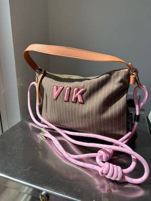 a brown and pink purse sitting on top of a table