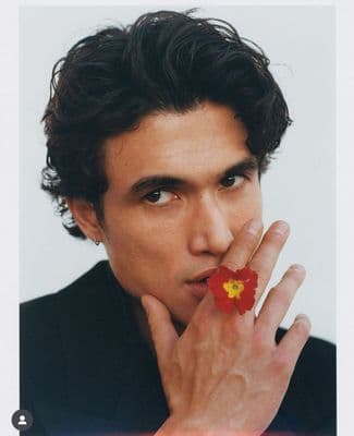 a man with a flower on his finger