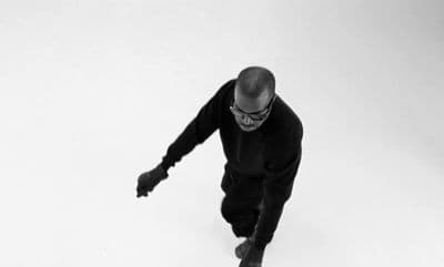 a black and white photo of a man on a skateboard