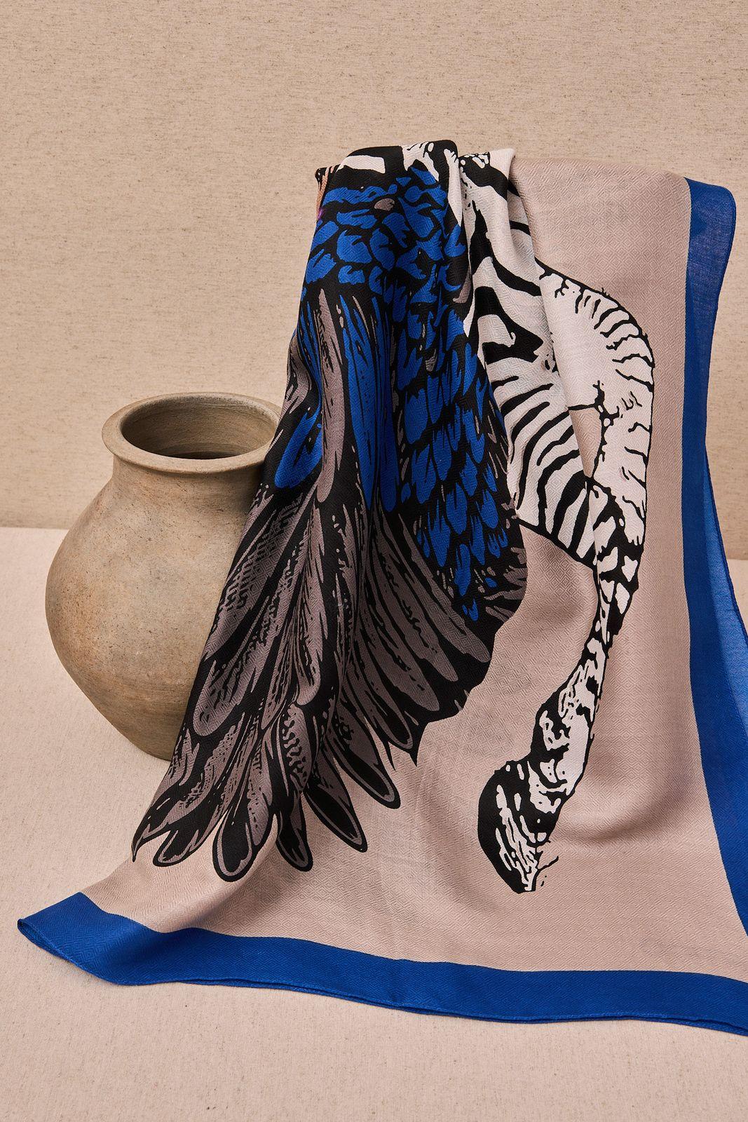 a blue and white scarf sitting on top of a table