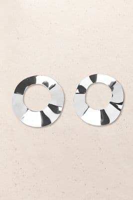 a pair of circular earrings on a beige background