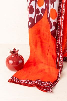 a red apple sitting on top of a table next to a piece of cloth