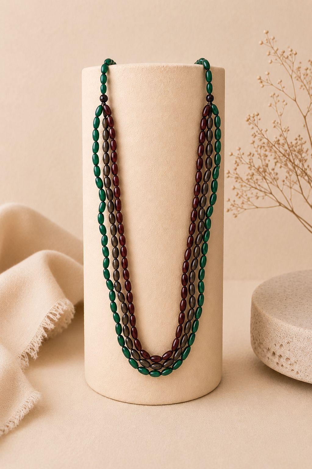 a close up of a necklace on a stand