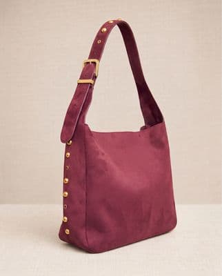 a pink bag with a gold buckle on it