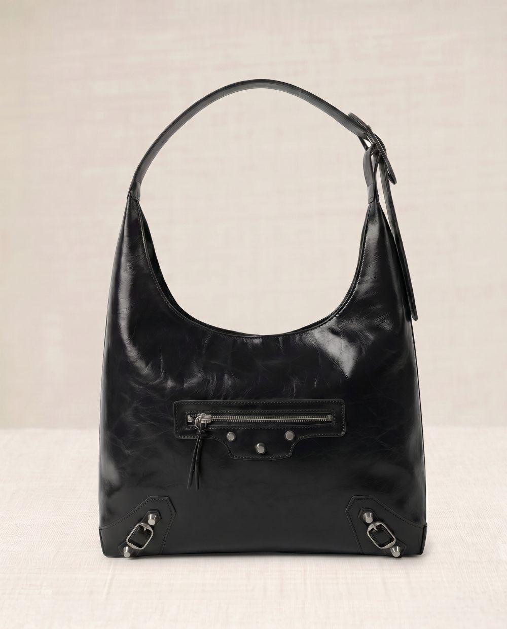 a black handbag sitting on top of a table